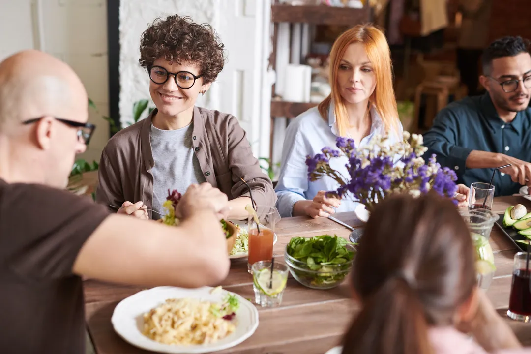 Adults sharing a meal around a table