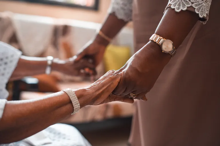 Two people holding hands