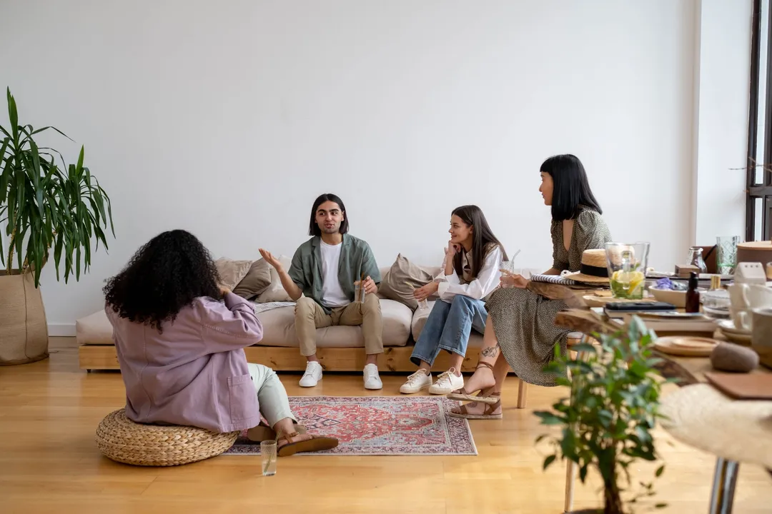 Adults talking together in a living room